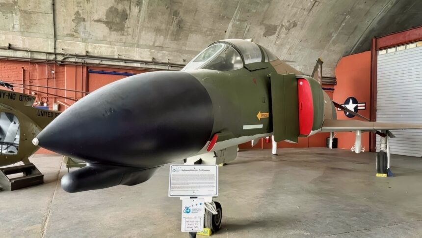 A Fully Loaded with Bombs US Air Force F-4 Phantom Fighter Rolled Upside Down Underneath a Tanker at Night in a Thunderstorm To Get Separation