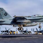 USS Abraham Lincoln is 305 days into a cruise that is now the second-longest U.S. aircraft carrier deployment since the Cold War and after Iran combat, 208 days straight at sea, and a one-day stop at Naval Base Guam the strike group is still weeks from San Diego