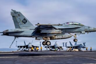 USS Abraham Lincoln is 305 days into a cruise that is now the second-longest U.S. aircraft carrier deployment since the Cold War and after Iran combat, 208 days straight at sea, and a one-day stop at Naval Base Guam the strike group is still weeks from San Diego