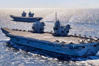 A 65,000-ton aircraft carrier that cost £6.2 billion and £96 million a year to keep defends itself with three Gatling guns that reach about two kilometers and nothing that fires farther, leans on destroyers its navy is short of, and keeps getting sunk in exercises